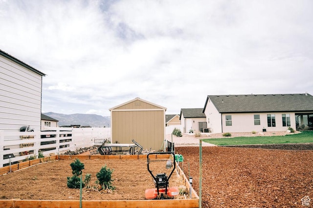 2366 W 3750 N, Cedar City, UT 84721 - view of yard featuring a garden, fence, a mountain view, an outdoor structure, and a shed