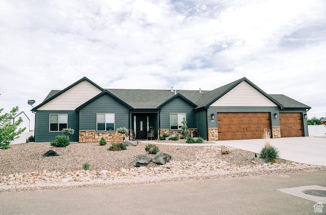 2366 W 3750 N, Cedar City, UT 84721 - view of front of house with stone siding, an attached garage, concrete driveway, and roof with shingles