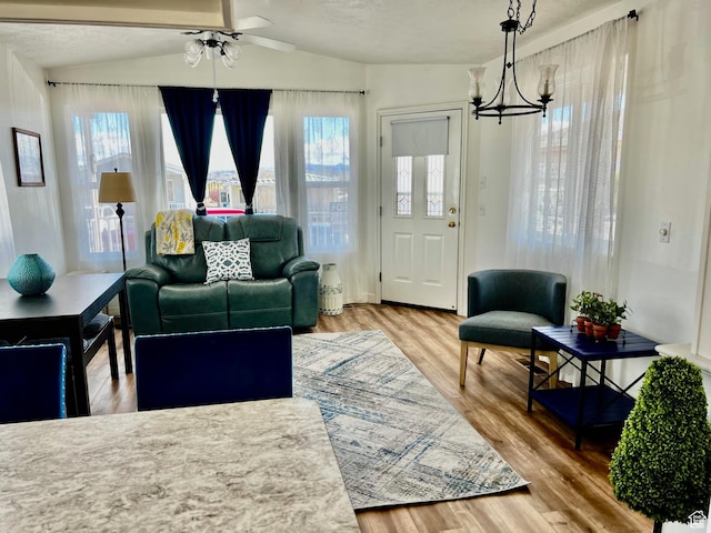 1150 W Red Hills Pkwy Unit 140, Washington, UT 84780 - living area featuring wood finished floors, a chandelier, vaulted ceiling, and a ceiling fan