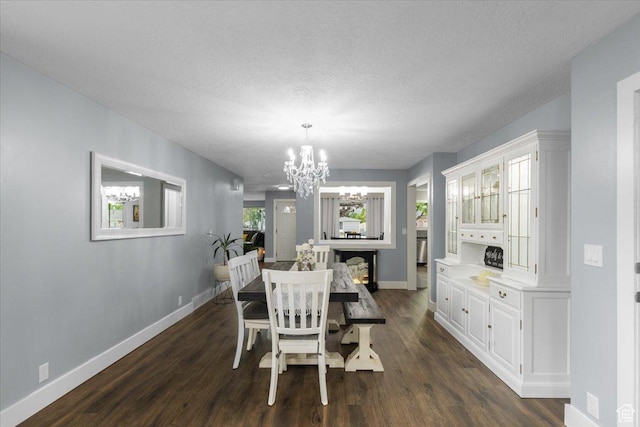 131 N 100 W, Hyrum, UT 84319 - dining area with a chandelier, baseboards, dark wood-type flooring, and a textured ceiling