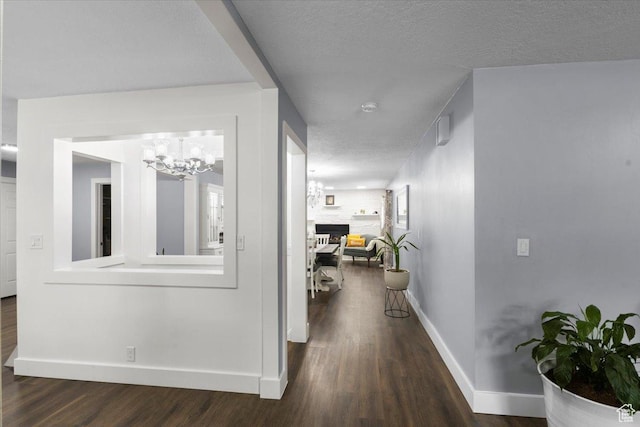 131 N 100 W, Hyrum, UT 84319 - corridor featuring wood finished floors, baseboards, a chandelier, and a textured ceiling