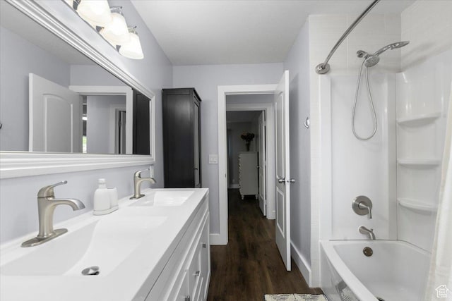 131 N 100 W, Hyrum, UT 84319 - bathroom with bathing tub / shower combination, wood finished floors, double vanity, and baseboards