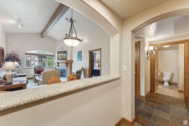 840 Bigler Ln Unit 3031, Midway, UT 84049 - hallway with baseboards, arched walkways, and stone tile flooring