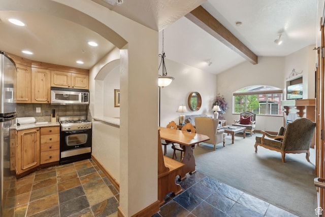 840 Bigler Ln Unit 3031, Midway, UT 84049 - kitchen with appliances with stainless steel finishes, stone tile floors, backsplash, arched walkways, and recessed lighting