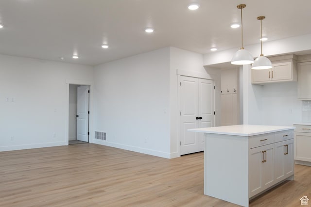 743 E 1250 S, Hyrum, UT 84319 - kitchen with light wood-style flooring, a kitchen island, light countertops, recessed lighting, and decorative light fixtures