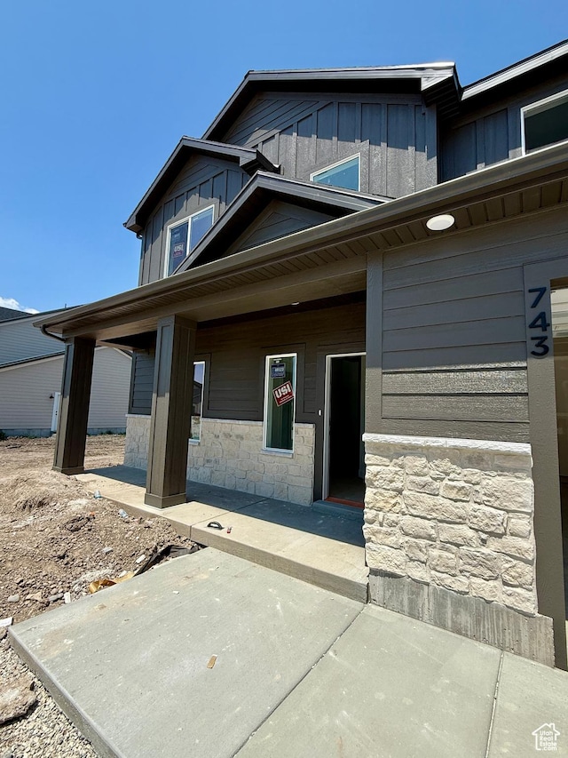 743 E 1250 S, Hyrum, UT 84319 - view of front facade with board and batten siding, stone siding, and a porch