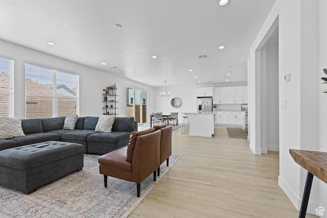 1445 N Arena Roja Dr, Washington, UT 84780 - living room with light wood finished floors, recessed lighting, and baseboards