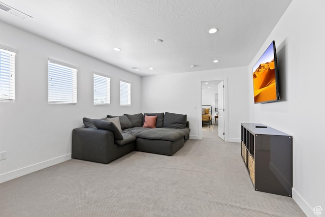 1445 N Arena Roja Dr, Washington, UT 84780 - living room featuring light colored carpet, recessed lighting, baseboards, and a textured ceiling