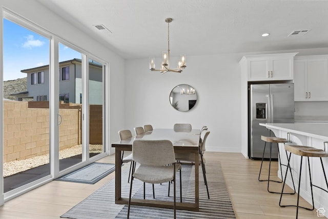1445 N Arena Roja Dr, Washington, UT 84780 - dining room featuring light wood-type flooring, a chandelier, baseboards, and recessed lighting