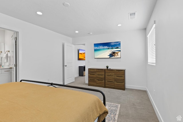 1445 N Arena Roja Dr, Washington, UT 84780 - bedroom featuring light carpet, recessed lighting, baseboards, and ensuite bath