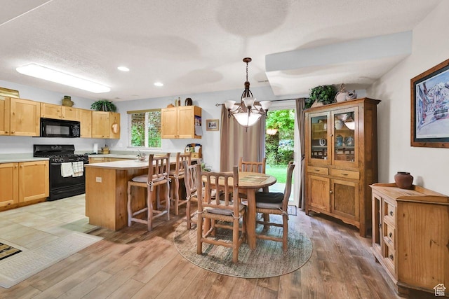 1076 E Creekside, Ogden, UT 84404 - dining space with a chandelier, light wood-type flooring, recessed lighting, and a textured ceiling
