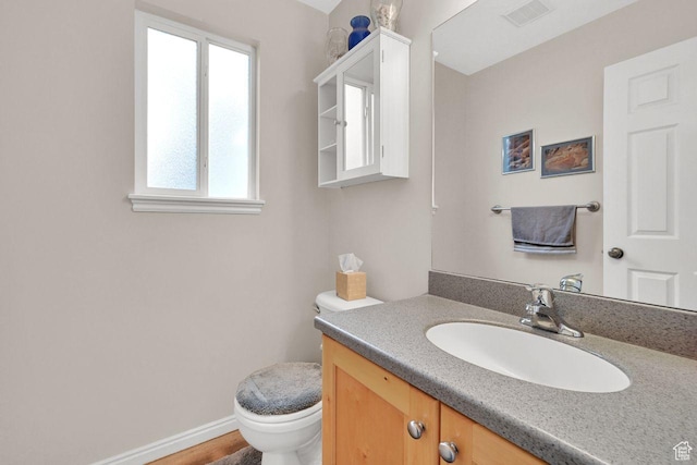 1076 E Creekside, Ogden, UT 84404 - bathroom with healthy amount of natural light, toilet, vanity, and baseboards