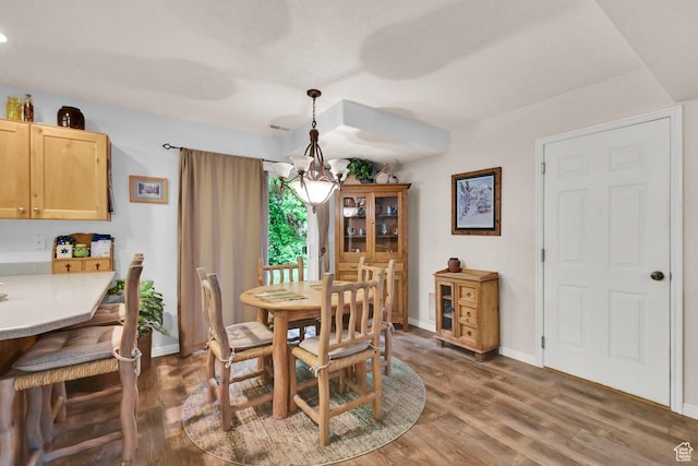 1076 E Creekside, Ogden, UT 84404 - dining area featuring a chandelier, wood finished floors, and baseboards