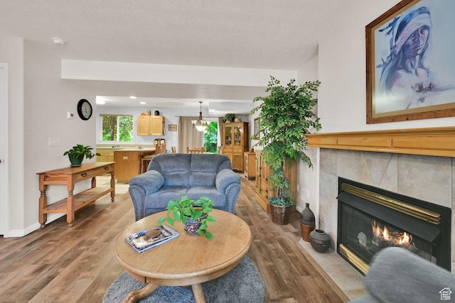 1076 E Creekside, Ogden, UT 84404 - living area with wood finished floors, a tile fireplace, and baseboards
