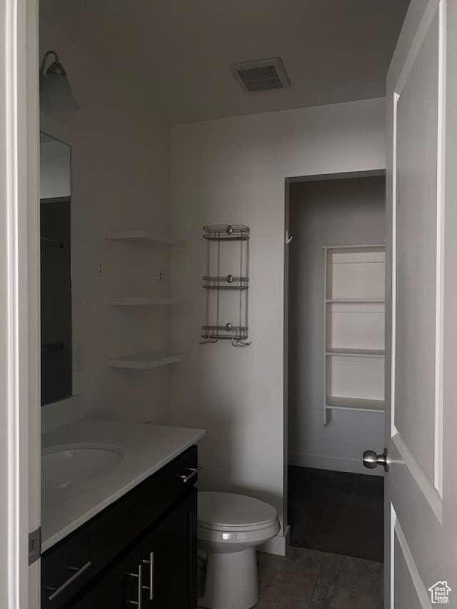 5841 W Lake Ave, South Jordan, UT 84009 - full bathroom featuring vanity, toilet, and tile patterned flooring