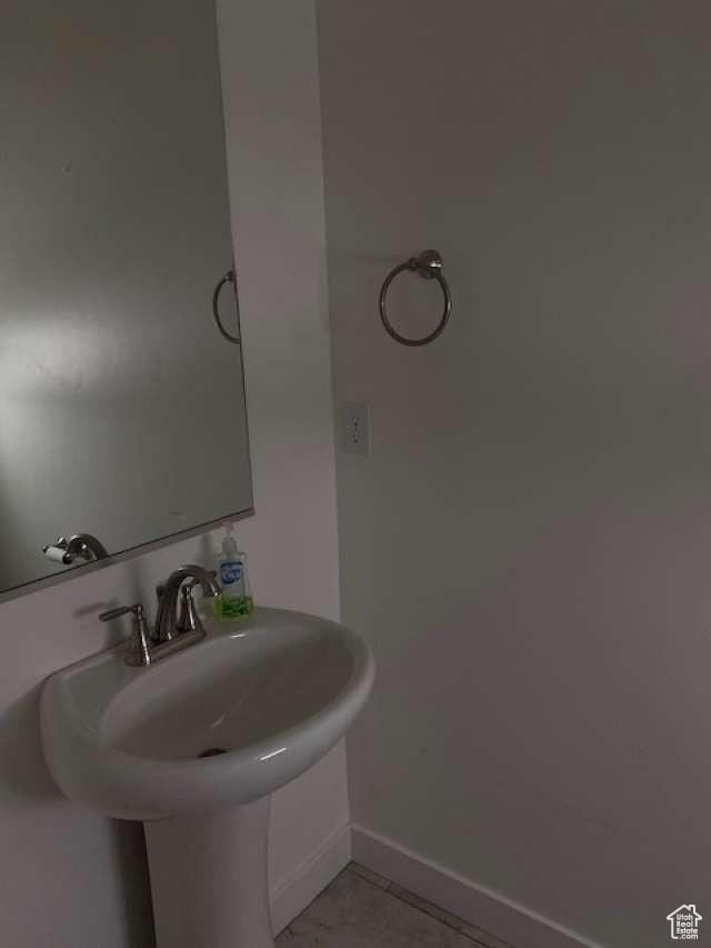 5841 W Lake Ave, South Jordan, UT 84009 - bathroom with baseboards, tile patterned flooring, and a sink