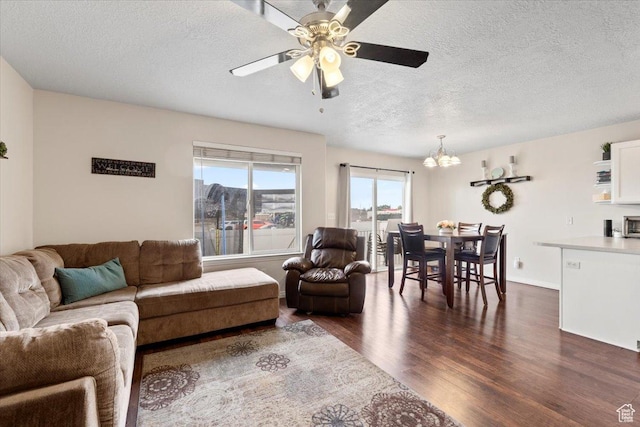 1298 S 1410 E, Provo, UT 84606 - living room with a chandelier, dark wood-type flooring, a textured ceiling, and a ceiling fan