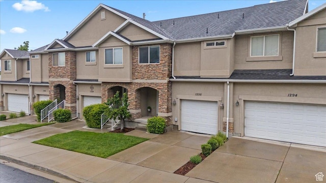 1298 S 1410 E, Provo, UT 84606 - townhome / multi-family property featuring stone siding, stucco siding, an attached garage, and driveway