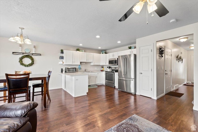1298 S 1410 E, Provo, UT 84606 - kitchen with stainless steel appliances, a peninsula, a sink, light countertops, and a textured ceiling
