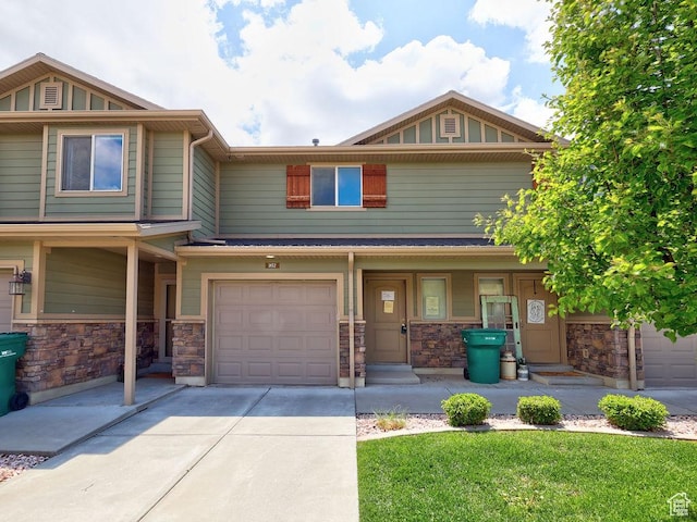 1852 E Whitetail Dr N Unit 106, Layton, UT 84040 - view of front of house with covered porch, driveway, an attached garage, and stone siding