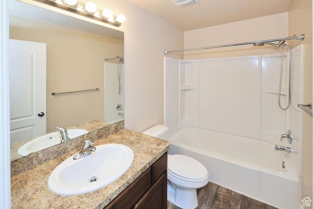 1852 E Whitetail Dr N Unit 106, Layton, UT 84040 - bathroom featuring washtub / shower combination, wood finished floors, vanity, and toilet