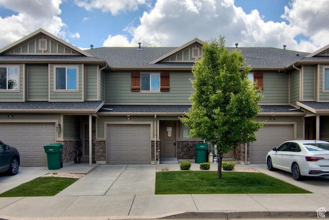 1852 E Whitetail Dr N Unit 106, Layton, UT 84040 - view of property featuring an attached garage, driveway, and roof with shingles