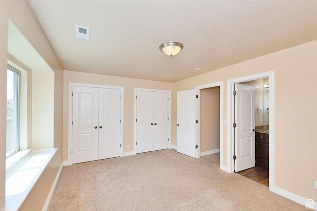 1852 E Whitetail Dr N Unit 106, Layton, UT 84040 - unfurnished bedroom featuring carpet, multiple closets, baseboards, and ensuite bathroom