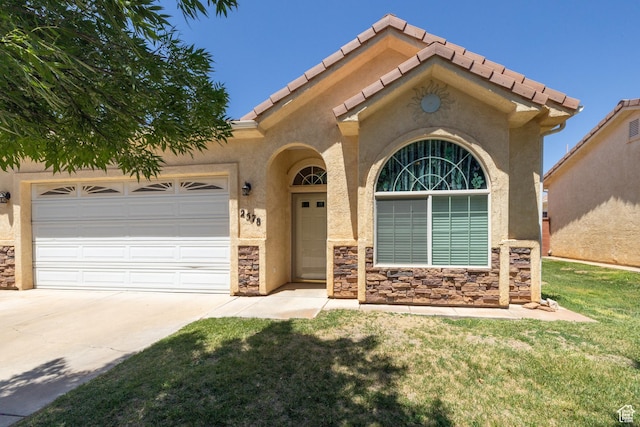 2578 W 225 N, Hurricane, UT 84737 - mediterranean / spanish-style house featuring a garage, driveway, stucco siding, and a front lawn