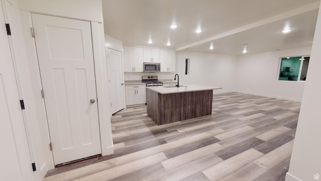 920 S 25 E # 18E, Cedar City, UT 84720 - kitchen with stainless steel appliances, white cabinetry, light wood-style flooring, a sink, and recessed lighting