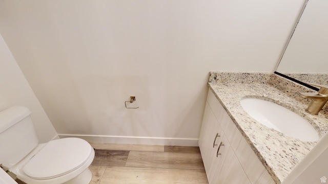 920 S 25 E # 18E, Cedar City, UT 84720 - half bathroom featuring baseboards, wood finished floors, toilet, and vanity