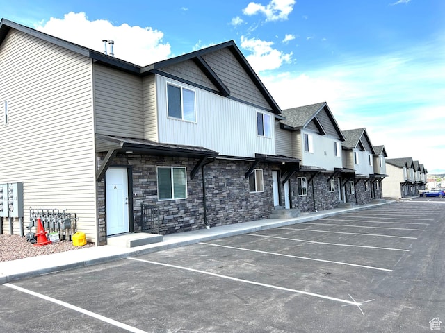 920 S 25 E # 18E, Cedar City, UT 84720 - view of building exterior with uncovered parking and a residential view