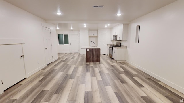 920 S 25 E # 18E, Cedar City, UT 84720 - kitchen with appliances with stainless steel finishes, a sink, recessed lighting, white cabinetry, and light wood-type flooring