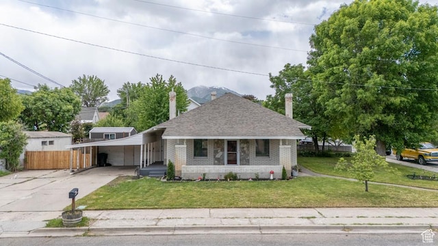 212 E 100 S, Payson, UT 84651 - bungalow-style house featuring brick siding, driveway, a chimney, roof with shingles, and an attached carport