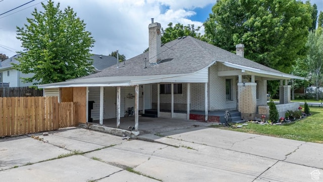 212 E 100 S, Payson, UT 84651 - rear view of house featuring driveway, a chimney, a shingled roof, and an attached carport