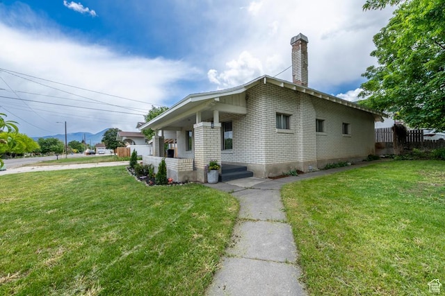 212 E 100 S, Payson, UT 84651 - view of side of home with brick siding, a chimney, and covered porch