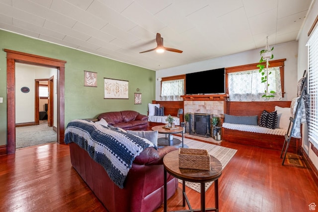 212 E 100 S, Payson, UT 84651 - living area featuring a tiled fireplace, hardwood / wood-style floors, a ceiling fan, and baseboards