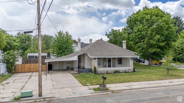 212 E 100 S, Payson, UT 84651 - bungalow with driveway, brick siding, an attached carport, roof with shingles, and covered porch