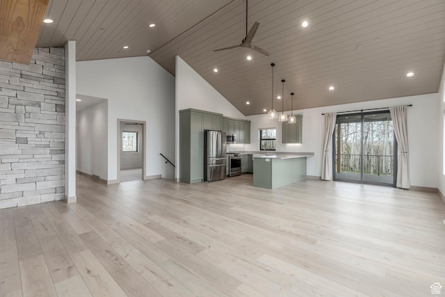 unfurnished living room with high vaulted ceiling, baseboards, light wood-style flooring, a ceiling fan, and recessed lighting