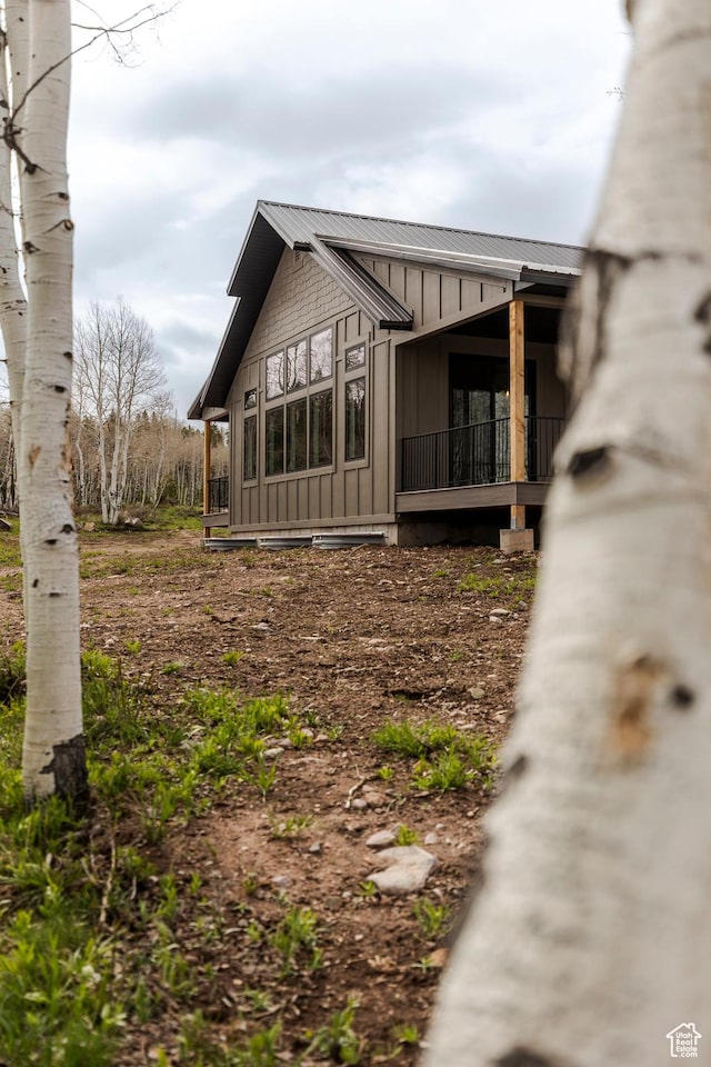 view of side of home with board and batten siding and metal roof