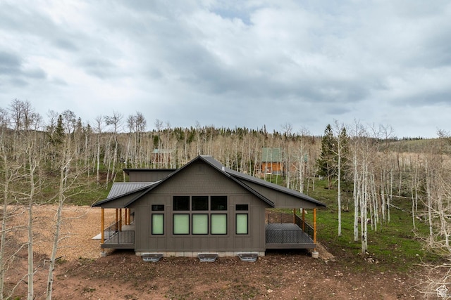 back of house with a forest view