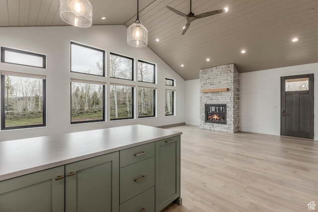 kitchen featuring high vaulted ceiling, green cabinetry, open floor plan, light countertops, and ceiling fan