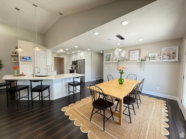 dining room with dark wood finished floors, baseboards, recessed lighting, and lofted ceiling