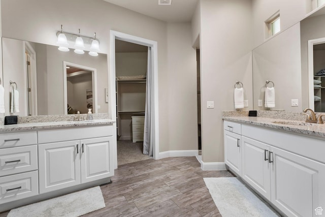 3258 S 4900 W, Hurricane, UT 84737 - bathroom featuring two vanities, baseboards, wood finished floors, and a walk in closet
