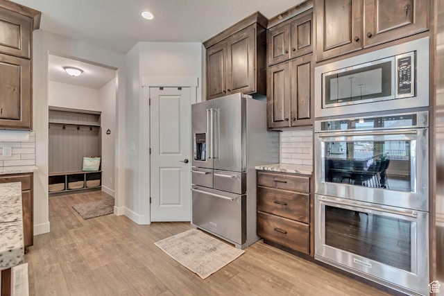 487 W 500 N, Mapleton, UT 84664 - kitchen with stainless steel appliances, backsplash, light wood finished floors, light stone countertops, and recessed lighting