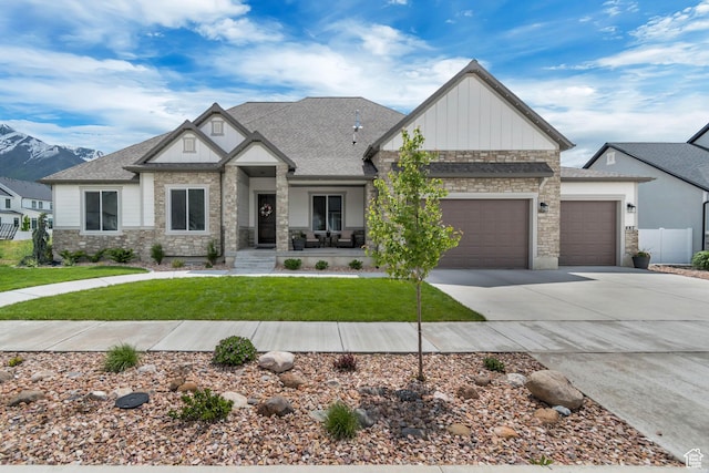 487 W 500 N, Mapleton, UT 84664 - view of front of home with a garage, stone siding, board and batten siding, driveway, and a front yard