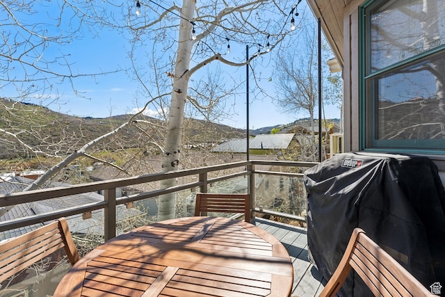 wooden terrace featuring a mountain view and area for grilling