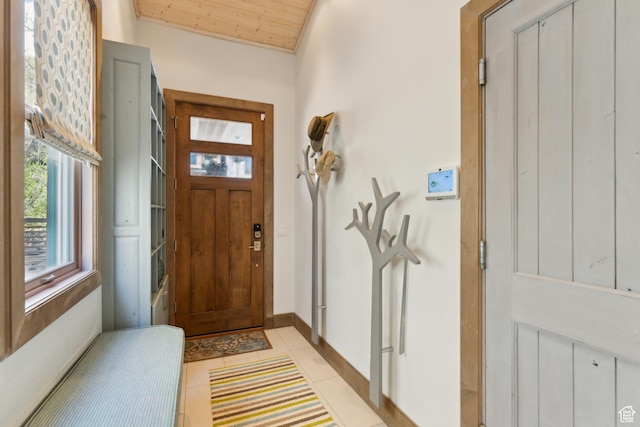 entryway featuring light tile patterned flooring and baseboards