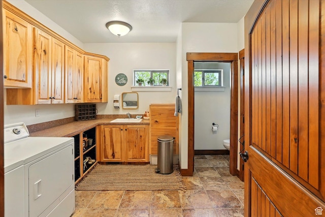 3703 W 600 S, Logan, UT 84321 - clothes washing area featuring separate washer and dryer, light stone finish flooring, and cabinet space
