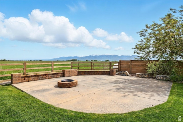 3703 W 600 S, Logan, UT 84321 - view of patio with an outdoor fire pit, a mountain view, fence, and a view of rural / pastoral area
