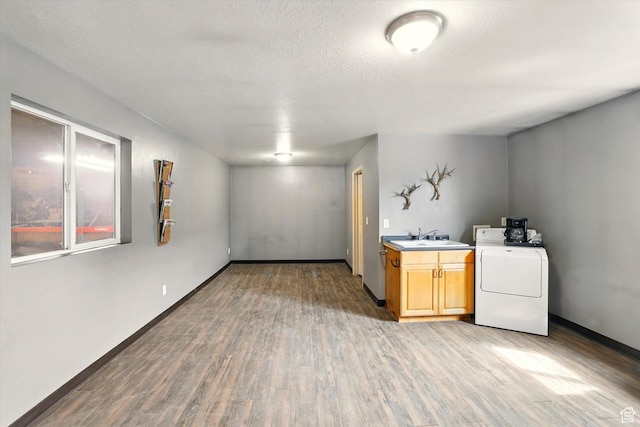 3703 W 600 S, Logan, UT 84321 - basement with washer / dryer, a sink, light wood-style flooring, and baseboards